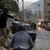Đụng độ giữa người Palestine và binh sĩ quân đội Israel tại thành phố Nablus, khu Bờ Tây, ngày 22/12/2022. (Ảnh: AFP/TTXVN)