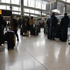 Hành khách chờ lên máy bay tại sân bay Heathrow ở thủ đô London, Anh. (Ảnh: AFP/TTXVN)