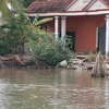 Một nhà dân ở Tiền Giang bị sụp xuống sông do ảnh hưởng của biến đổi khí hậu. (Ảnh: Minh Trí/TTXVN)