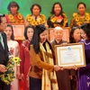 Bà Trương Thị Mai, Ủy viên Bộ Chính trị, Bí thư Trung ương Đảng, Trưởng ban Dân vận Trung ương trao tặng Bằng khen của Hội LHPN Việt Nam cho các phụ nữ điển hình tiên tiến. (Ảnh: TTXVN)