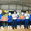 Thủ tướng Phạm Minh Chính tặng quà cho công nhân Công ty cổ phần thực phẩm xuất khẩu Đồng Giao. (Ảnh: Dương Giang/TTXVN)