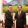 Ông Bounthong Chitmany, Ủy viên Bộ Chính trị, Thường trực Ban Bí thư, Phó Chủ tịch nước Lào tiếp ông Lê Quốc Minh cùng đoàn. (Ảnh: Phạm Kiên/TTXVN)