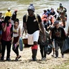 Người di cư tới trung tâm tiếp nhận người tị nạn ở Lajas Blancas, Darien, Panama, ngày 28/6/2024. (Ảnh: Getty Images/TTXVN)