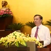 Bộ trưởng Bộ Tài chính Đinh Tiến Dũng trình bày báo Tờ trình về dự án Luật thuế xuất khẩu, thuế nhập khẩu (sửa đổi). (Ảnh: Phương Hoa/TTXVN) 