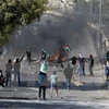 Cuộc đụng độ giữa người Palestine và lực lượng an ninh Israel tại Đông Jerusalem ngày 4/10. (Ảnh: Reuters/TTXVN)