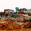 Chôn lấp rác thải ở bãi rác Nam Sơn. (Ảnh :Bùi Tường/TTXVN)
