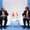 Thủ tướng Nguyễn Xuân Phúc gặp Tổng thống Indonesia Joko Widodo. (Ảnh: Thống Nhất/TTXVN)