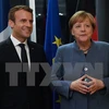 Thủ tướng Đức Angela Merkel (phải) và Tổng thống Pháp Emmanuel Macron. (Nguồn: AFP/TTXVN)