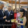 Các đại biểu dùng thử sản phẩm Tuần hàng Việt Nam tại Thái Lan. (Ảnh: PV/Vietnam+)
