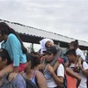 Người di cư Honduras trên cây cầu ở vùng biên giới giữa Guatemala và Mexico trong hành trình tới Mỹ ngày 20/10. (Nguồn: AFP/TTXVN) 