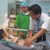 Sản phụ Trịnh Thị Mỵ Thúy đang được theo dõi, điều trị tại Bệnh viện Đa khoa Đồng Nai. (Ảnh: Lê Xuân/TTXVN)
