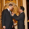 Thứ trưởng Bộ Ngoại giao Việt Nam Tô Anh Dũng gắn Huân chương Hữu nghị của Chủ tịch nước cho ông Christian Berger. (Ảnh: Dương Giang/TTXVN)