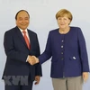 Thủ tướng Đức Angela Merkel và Thủ tướng Nguyễn Xuân Phúc. (Ảnh: Thống Nhất/TTXVN)