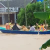 Di chuyển người dân ra khỏi khu vực ngập lũ tại huyện Cam Lộ (Quảng Trị). (Ảnh: Thanh Thủy/TTXVN)