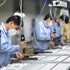 Công nhân sản xuất tại một phân xưởng ở Quảng Châu, thủ phủ tỉnh Quảng Đông, Trung Quốc. (Ảnh: THX/TTXVN) 