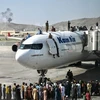 Nhiều người dân Afghanistan đã đu lên nóc máy bay để ngồi chờ được bay.(Nguồn: AFP) 
