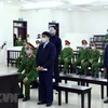 Bị cáo Nguyễn Đức Chung và đồng phạm tại phiên tòa. (Ảnh: Phạm Kiên/TTXVN) 