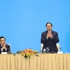 Thủ tướng Phạm Minh Chính và Thủ tướng Lào Phankham Viphavanh gặp gỡ doanh nghiệp hai nước. (Ảnh: Dương Giang/TTXVN) 