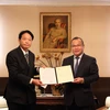 Đại sứ Vũ Hồng Nam (bên phải) trao quyết định bổ nhiệm cho Giáo sư Natsume. (Ảnh: Đào Thanh Tùng/TTXVN)