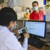 Kiểm tra thông tin bảo hiểm y tế trên ứng dụng VssID để đăng ký khám bệnh tại Trung tâm Y tế huyện Mường Chà. (Ảnh: Xuân Tư/TTXVN)