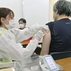 Nhân viên y tế tiêm chủng vaccine ngừa COVID-19 cho người dân tại Osaka, Nhật Bản. (Ảnh: Kyodo/TTXVN)