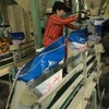 Đóng gói sản phẩm gạo xuất khẩu của Công ty TNHH Gạo Vinh Phát ở phường Thới Thuận, quận Thốt Nốt, thành phố Cần Thơ. (Ảnh: Vũ Sinh/TTXVN)