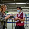 Nhân viên sân bay kiểm tra hộ chiếu của một hành khách tại sân bay Don Mueang ở Bangkok, Thái Lan. (Ảnh: AFP/TTXVN)