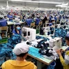 Sản xuất hàng may mặc xuất khẩu tại Công ty may mặc New Apparel, Khu công nghiệp Bắc Đồng Phú, tỉnh Bình Phước. (Ảnh: Dương Chí Tưởng/TTXVN) 