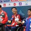 Nguyễn Hoàng Nhã (giữa) giành huy chương Vàng nội dung bơi ngửa nam 100m hạng thương tật S7, phá kỷ lục. (Ảnh: Hoàng Minh/TTXVN) 