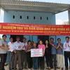 Bàn giao tiền hỗ trợ xây dựng nhà đại đoàn kết cho bà Nguyễn Thị Lánh, trú tại thôn Lãnh Tú, xã Xuân Lãnh, huyện Đồng Xuân. (Ảnh: TTXVN phát)