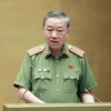 Bộ trưởng Bộ Công an Tô Lâm trình bày Tờ trình về dự án Luật Lực lượng tham gia bảo vệ an ninh, trật tự ở cơ sở. (Ảnh: Doãn Tấn/TTXVN)