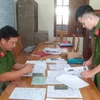 Cán bộ công an tỉnh Thái Bình thu thập hồ sơ, tài liệu trong một vụ án lừa đảo đi làm việc nước ngoài. (Ảnh: TTXVN phát)