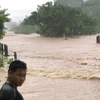 Mưa lớn làm ngập nhiều đoạn đường tại tỉnh Bolykhamxay, Trung Lào. (Ảnh TTXVN phát)