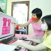Chị Nghiêm Thị Thu Hường, Chủ nhiệm Cơ sở May Công nghiệp của người khuyết tật tỉnh Lạng Sơn hướng dẫn học viên thiết kế quần áo trên máy tính. (Ảnh: Anh Tuấn/ TTXVN)