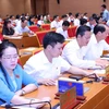 Đại biểu biểu quyết về việc tán thành chủ trương sắp xếp đơn vị hành chính cấp huyện, cấp xã giai đoạn 2023-2025 của thành phố Hà Nội. (Ảnh: Văn Điệp/TTXVN)