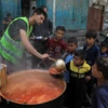 Trẻ em Palestine nhận thức ăn cứu trợ tại thành phố Rafah, Dải Gaza ngày 28/4/2024. (Ảnh: THX/TTXVN)