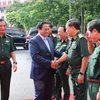 Thủ tướng Phạm Minh Chính và các đồng chí lãnh đạo Bộ Quốc phòng dự hội nghị. (Ảnh: Trọng Đức/TTXVN)