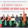 Chính quyền và Nhân dân huyện Bù Đăng đón nhận Huân chương Lao động hạng Nhì. (Ảnh: Nhật Bình/TTXVN)