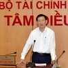 Bộ trưởng Bộ Tài chính Hồ Đức Phớc trao đổi trong buổi làm việc với Tập đoàn FPT. (Ảnh: Vietnam+) 