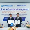 Công ty cổ phẩn Chứng khoán Mirae Asset và Ngân hàng Woori Việt Nam ký thỏa thuận hợp tác, ngày 16/9. (Ảnh: Vietnam+)