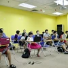 Những em nhỏ mê lập trình nhờ sự kèm cặp bởi những thầy cô giáo "không chuyên" của FPT. (Ảnh: H.T/Vietnam+)