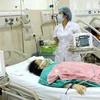 Nhân viên y tế chăm sóc cho bệnh nhân những ngày Tết. (Ảnh: TTXVN/Vietnam+)
