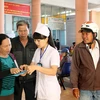 Nhân viên y tế hướng dẫn người dân khám chữa bệnh. (Ảnh: TTXVN/Vietnam+)