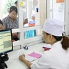 Làm thủ tục thanh toán bảo hiểm y tế ở Lào Cai. (Ảnh: Dương Ngọc/TTXVN)