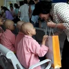 Phó Chủ tịch nước Đặng Thị Ngọc Thịnh tặng quà cho bệnh nhân mắc ung thư. (Ảnh: PV/Vietnam+)