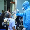 Nhân viên y tế lấy mẫu xét nghiệm người dân tại Quận 6, Thành phố Hồ Chí Minh. (Ảnh: Đinh Hằng/TTXVN)