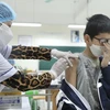 Nhân viên y tế tiêm vaccine phòng COVID-19 cho học sinh lớp 6 tại điểm tiêm chủng trường THCS Lê Ngọc Hân, quận Hai Bà Trưng, Hà Nội. (Ảnh: Minh Quyết/TTXVN)