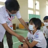 Khám sàng lọc sức khỏe cho trẻ trước khi tiêm chủng. (Ảnh: TTXVN/Vietnam+)