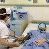 Bác sỹ tại Bệnh viện Phổi Trung ương khám cho một bệnh nhân. (Ảnh: PV/Vietnam+)