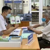 Bác sĩ Bệnh viện Phổi Trung ương tư vấn cho người dân về bệnh lao. (Ảnh: PV/Vietnam+)